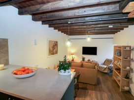 A living room with a television and a sofa at The Loft in Glenmore, County Kilkenny