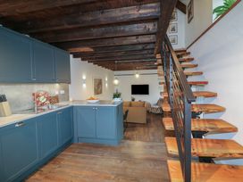 A kitchen with cabinets and a staircase at The Loft in Glenmore, County Kilkenny