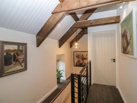 A hallway with a staircase and paintings at The Loft in Glenmore, County Kilkenny