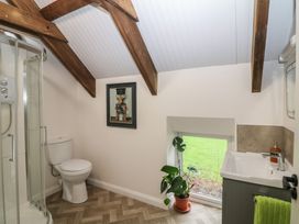 A bathroom featuring a shower, toilet, and sink at The Loft in Glenmore, County Kilkenny