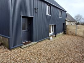 An exterior view of a gray metal building with a door and gravel area at The Loft in Glenmore, County Kilkenny