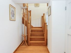 A staircase and coat rack in a hallway at Hilldown Granary near Bow