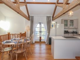 A kitchen with dining table and chairs at Hilldown Granary near Bow