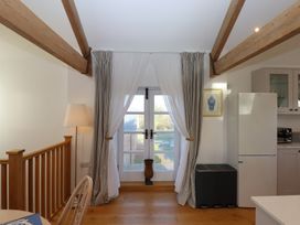 A kitchen with a window and fridge at Hilldown Granary near Bow
