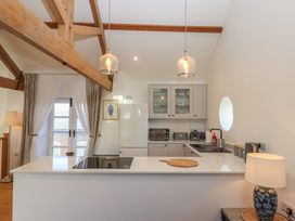 A kitchen with appliances and a kitchen island at Hilldown Granary near Bow