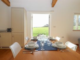 A dining room table set with plates and glasses at Hilldown Cott near Bow