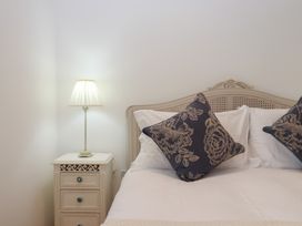 A bedroom with a bed and a lamp at Hilldown Cott near Bow