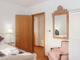 A bedroom with a bed and lamp at Hilldown Cott near Bow