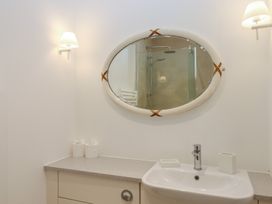 A bathroom with a sink and shower at Hilldown Cott near Bow
