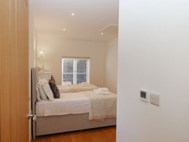 A bedroom with beds and a lamp at Hilldown Cott near Bow