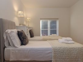 A bedroom with two beds and nightstands at Hilldown Cott near Bow