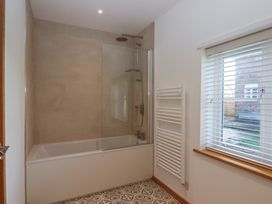 A bathroom with a bath and shower at Hilldown Cott near Bow