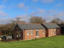 A house with a garden and seating area at Hilldown Cott near Bow