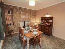 A dining room with a table set for a meal at Daisy cottage in Pickering