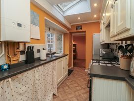 A kitchen with appliances and a worktop at Daisy cottage in Pickering