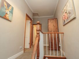 A staircase with artwork on the wall at Daisy cottage in Pickering