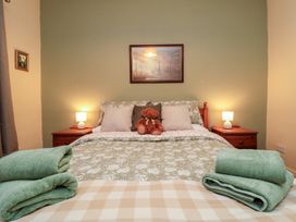 A bedroom with a bed and teddy bear at Daisy cottage in Pickering