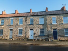 An exterior view of a stone terraced house at Daisy cottage Pickering
