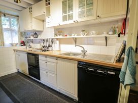 A kitchen with cabinets and appliances at Noddfa Penmachno
