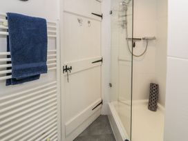 A bathroom with a shower and towel rail at Noddfa Penmachno