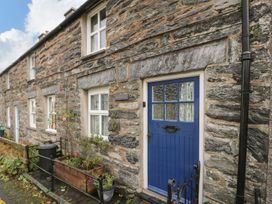 A blue door with windows and a planter outside at Noddfa in Penmachno