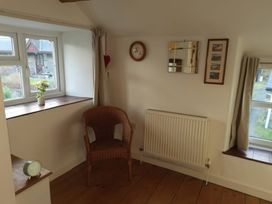 A snug with a chair and window at Noddfa in Penmachno