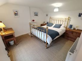 A bedroom with a bed and nightstands at Noddfa in Penmachno