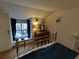 A bedroom featuring a bed and a window at Noddfa Penmachno