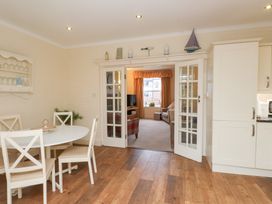 A dining room with a table and chairs at The Hideaway in Penrhyn Bay