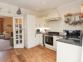 A kitchen with appliances and cookware at The Hideaway in Penrhyn Bay