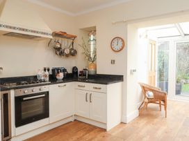 A kitchen with stove and cabinets at The Hideaway in Penrhyn Bay