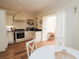 A kitchen with cabinets and appliances at The Hideaway in Penrhyn Bay