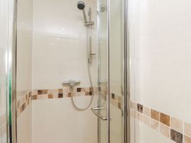 A shower with glass enclosure at The Hideaway in Penrhyn Bay