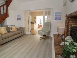 A living room with a sofa and chair at The Hideaway in Penrhyn Bay