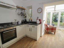 A kitchen with a stove and sink at The Hideaway in Penrhyn Bay