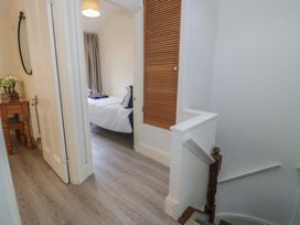 A hallway with a mirror and table at The Hideaway in Penrhyn Bay