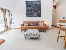 A living room with a sofa and artwork at 2 Trem Y Mor in Llanfwrog near Llanfachraeth