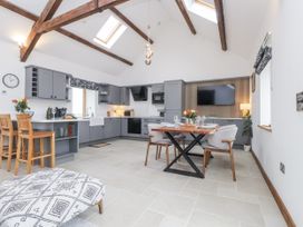 A kitchen with a dining area at 2 Trem Y Mor in Llanfwrog near Llanfachraeth