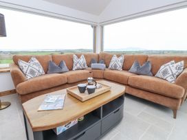 A snug with a sofa and coffee table at 2 Trem Y Mor Llanfwrog near Llanfachraeth