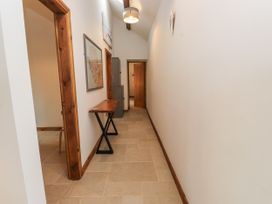A hallway with a table and doors at 2 Trem Y Mor Llanfwrog near Llanfachraeth