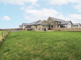 A house with a lawn and fence at 2 Trem Y Mor Llanfwrog near Llanfachraeth