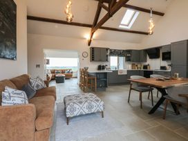 A living room and kitchen area with furniture at 2 Trem Y Mor Llanfwrog near Llanfachraeth
