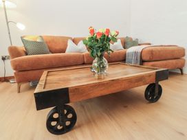 A living room with a sofa and coffee table at Hen Penmynydd, Llanfwrog near Llanfachraeth