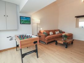 A living room with a foosball table and a sofa at Hen Penmynydd near Llanfwrog Llanfachraeth