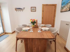 A dining room with a table set for a meal at Hen Penmynydd in Llanfwrog near Llanfachraeth