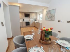 A dining room with a table set for meals at Hen Penmynydd in Llanfwrog near Llanfachraeth
