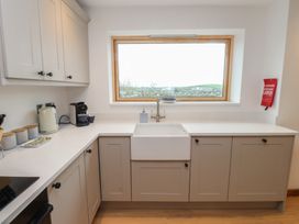 A kitchen with a sink and cupboards at Hen Penmynydd in Llanfwrog near Llanfachraeth