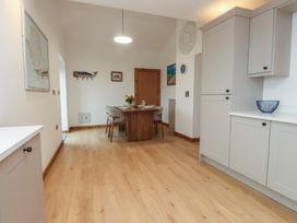 A dining room with a table and chairs at Hen Penmynydd in Llanfwrog near Llanfachraeth