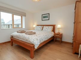 A bedroom with a bed and nightstand at Hen Penmynydd in Llanfwrog near Llanfachraeth