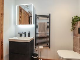 A bathroom with a sink and towel rack at Hen Penmynydd Llanfwrog near Llanfachraeth